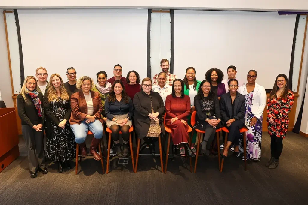 Cohort 9 poses in a classroom on NYU's campus.